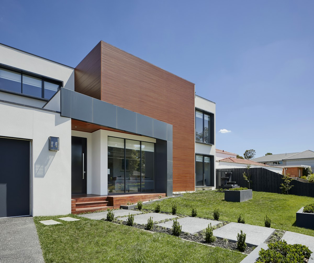 Modern home exterior with wood-and-white cladding and clean large windows, Chester County, PA